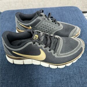 Black and gold Nike Frees